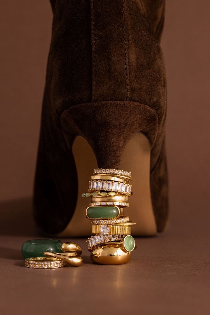 Ring stack resting on a suede heel