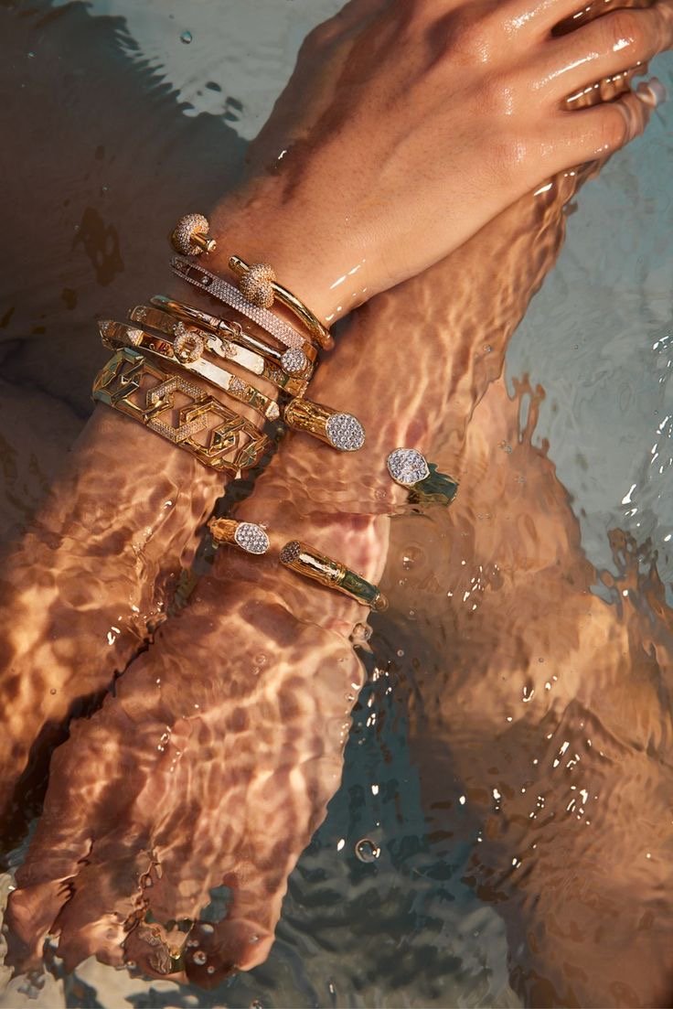 Diamond bangles catching light in rippling water